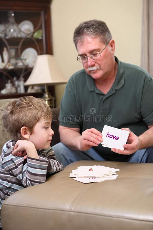 grandfather showing child flashcards