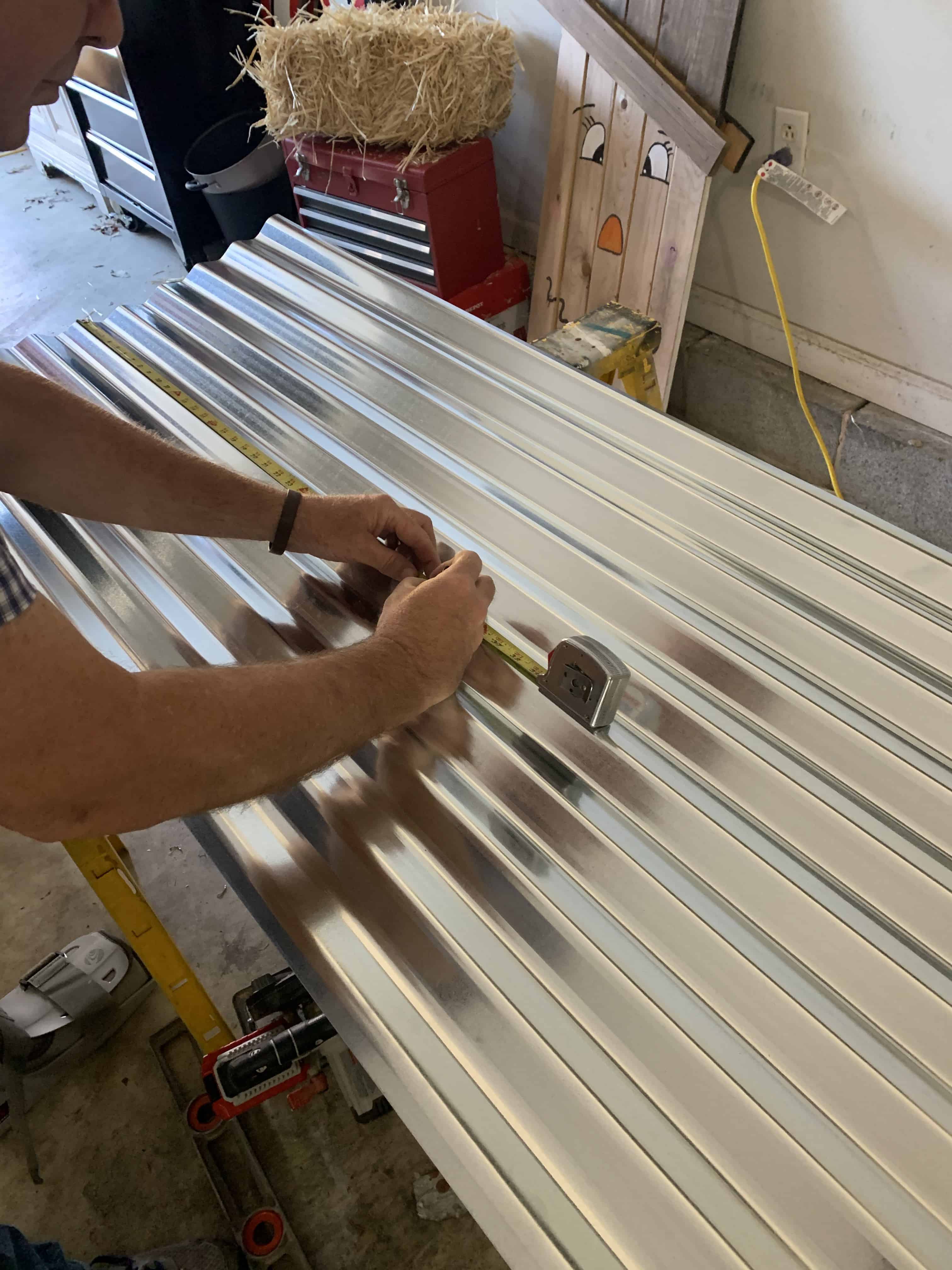 man measuring tin