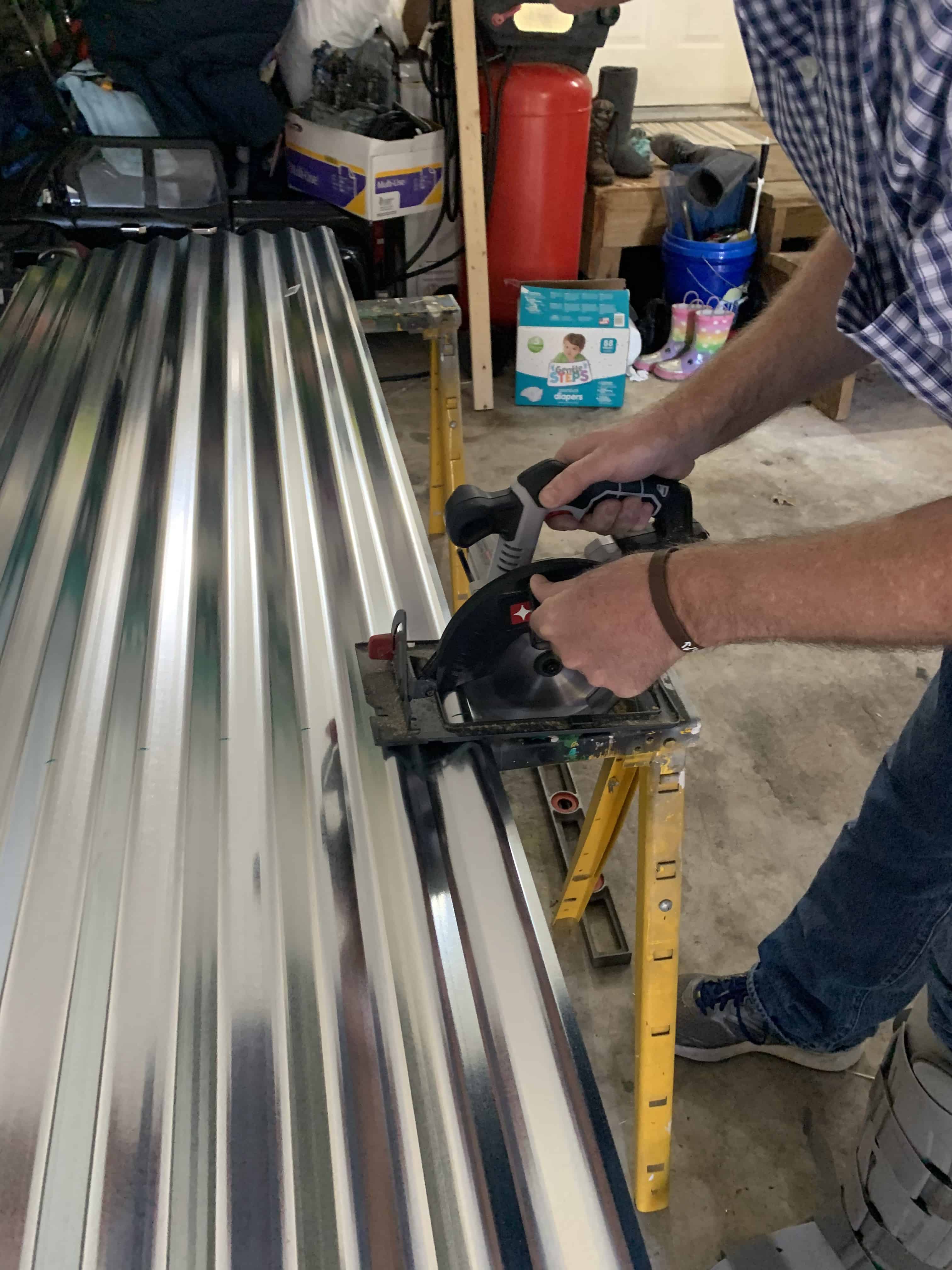 man sawing tin