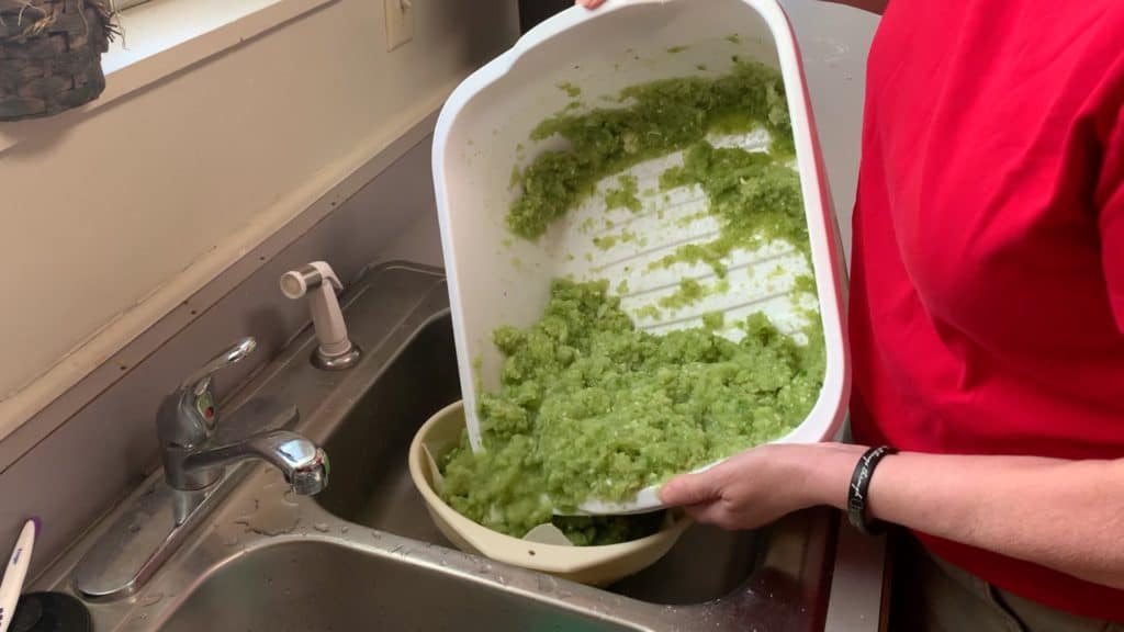 draining ingredients from a dishpan to a colander