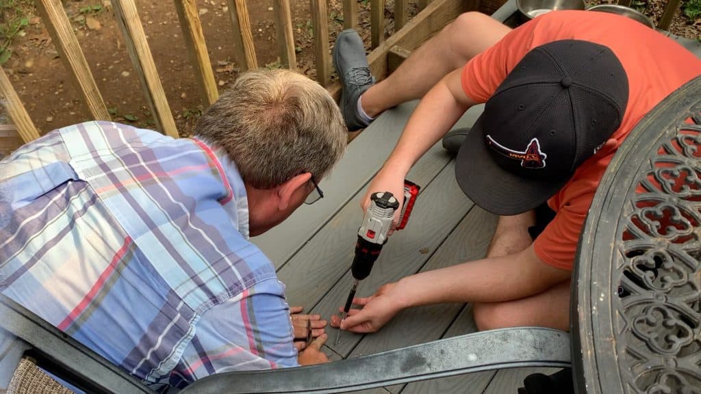 2 men screwing down deck